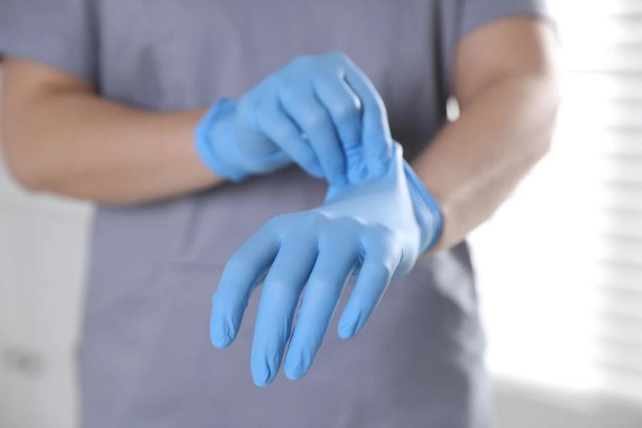 XL disposable gloves being worn by a person in a medical or hygiene setting, ensuring safety and cleanliness.