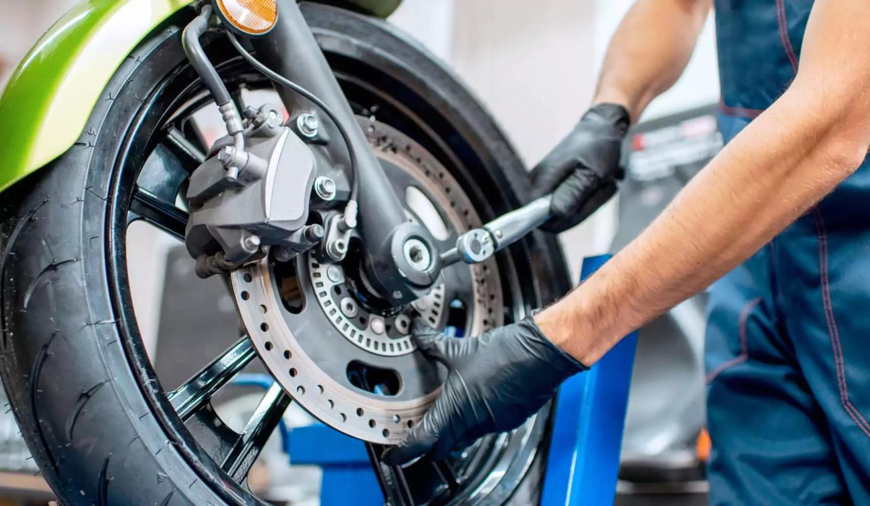 black nitrile gloves used for motorcycle brake maintenance in repair shop