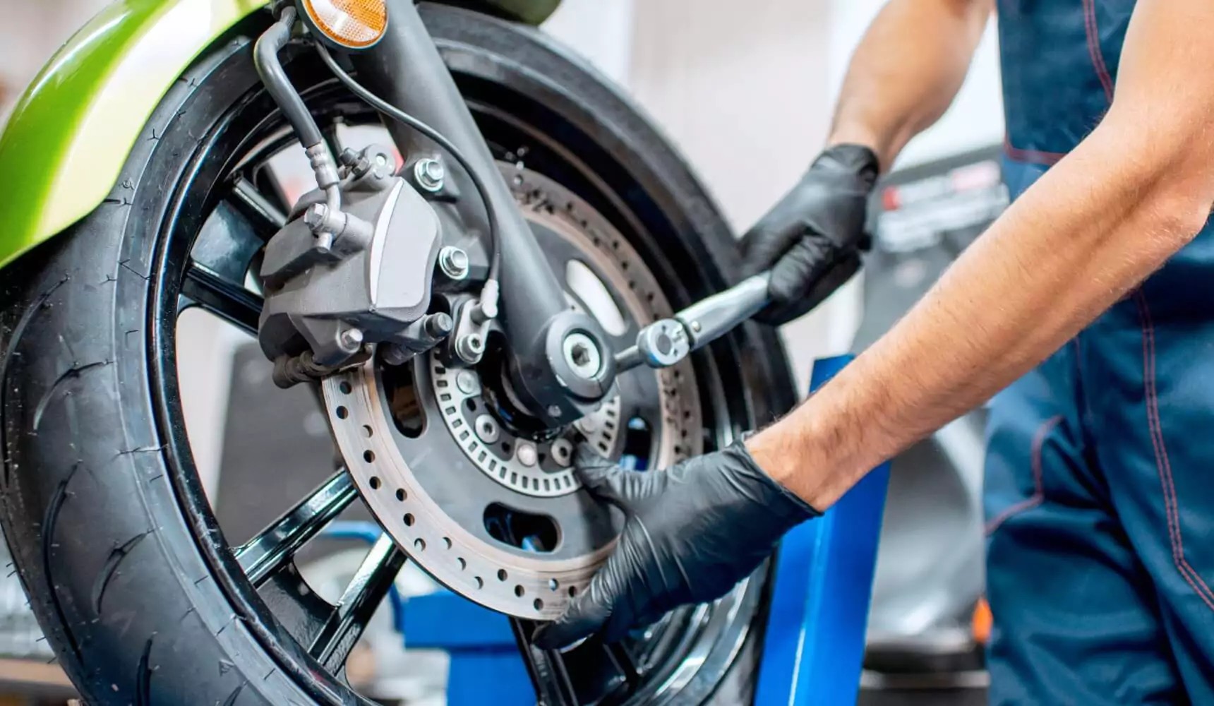 black nitrile gloves used for motorcycle brake maintenance in repair shop