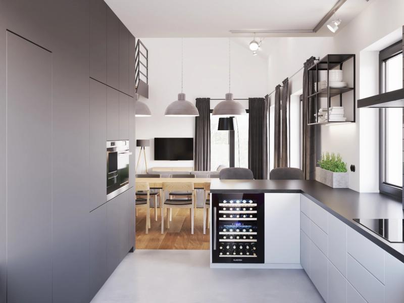 Widok w stronę salonu. Lodówka na wino ukryta w półwyspie.