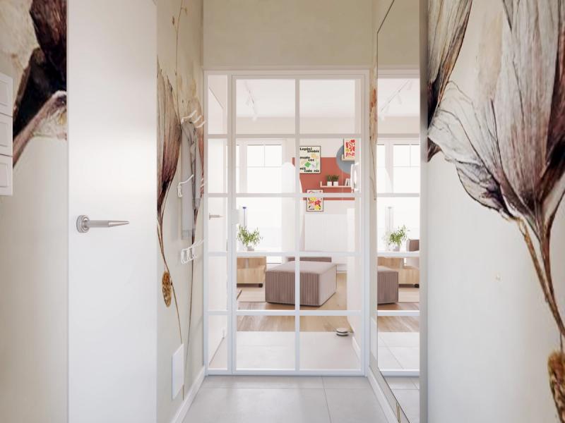 Przeszklone drzwi loftowe wpuszczają światło z salonu i powiększają wiatrołap optycznie. Tapeta przechodzi przez obie ściany.