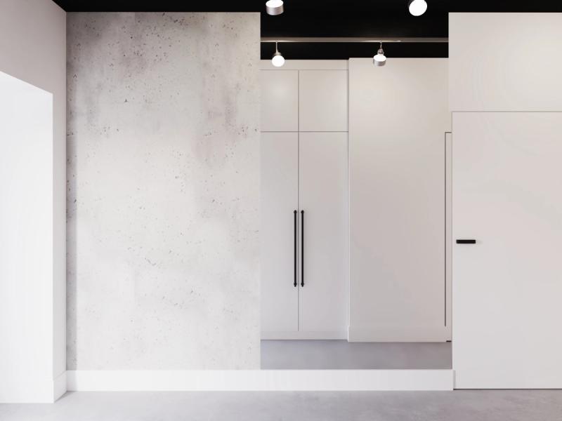 Betonowa ściana naprzeciwko wejścia. Loftowy akcent od pierwszego kroku.