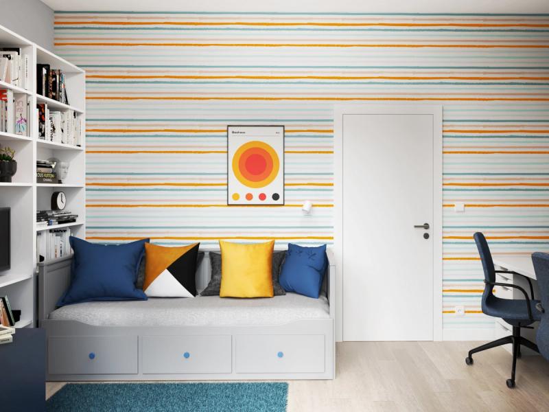 Tapeta w paski — żółte, miętowe, beżowe — na ścianie z łóżkiem. Poduszki w kolorach pokoju. Plakat Bauhaus. Łóżko rozkładane z szufladami.