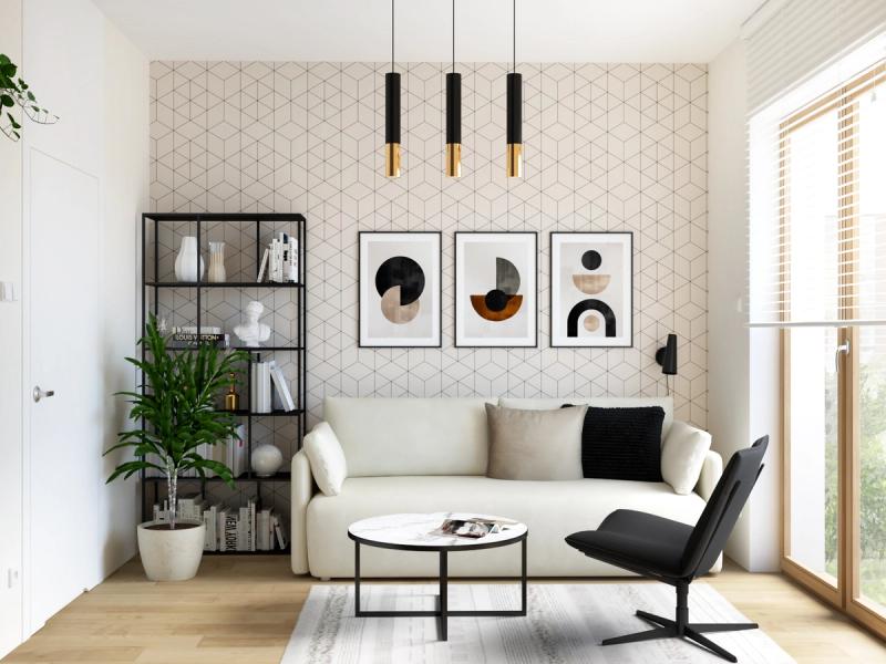 Tapeta geometryczna za sofą — trójwymiarowy wzór rombów na jasnym tle. Trzy abstrakcyjne grafiki w czarnych ramach. Metalowy regał zamiast klasycznej biblioteczki.