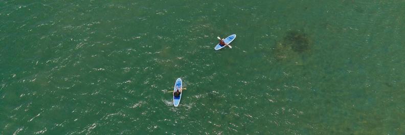 Aerial photo of two people on SUP Boards in the Mandurah estuary