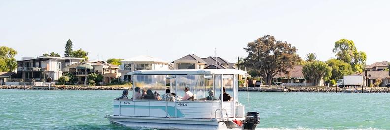 A pontoon motoring in the estuary