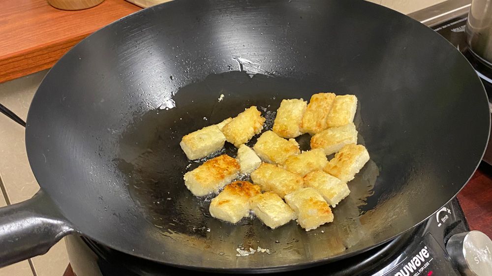 Tofu cooking in a wok