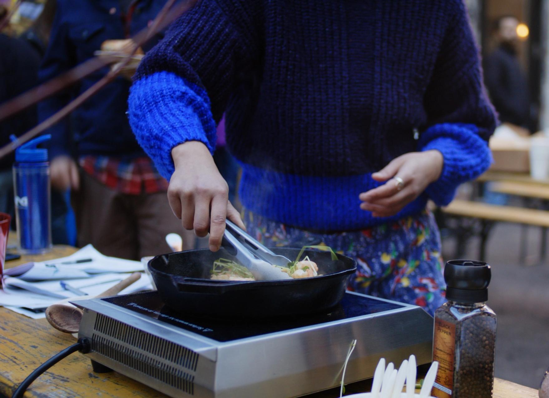 Woman cooking on induction cooktop