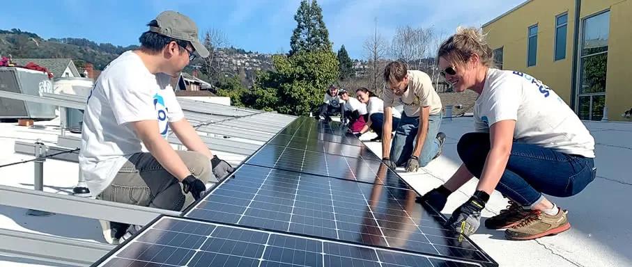Group of people installing solar panels