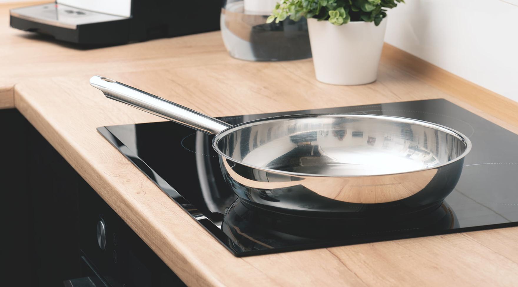Metal pan on an induction range in a kitchen