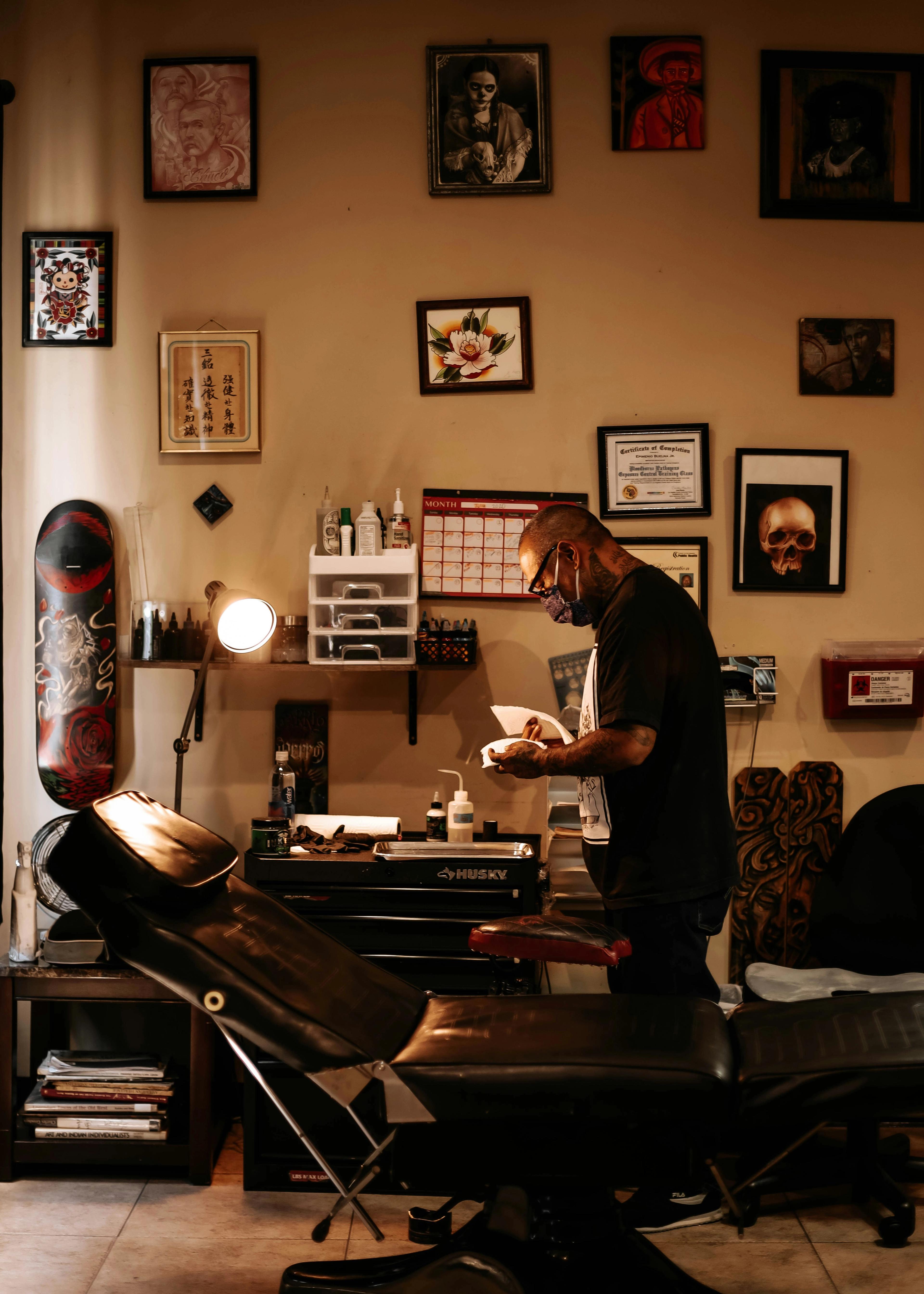 Interior of the Awesome Ink studio with a tattoo chair and framed artwork