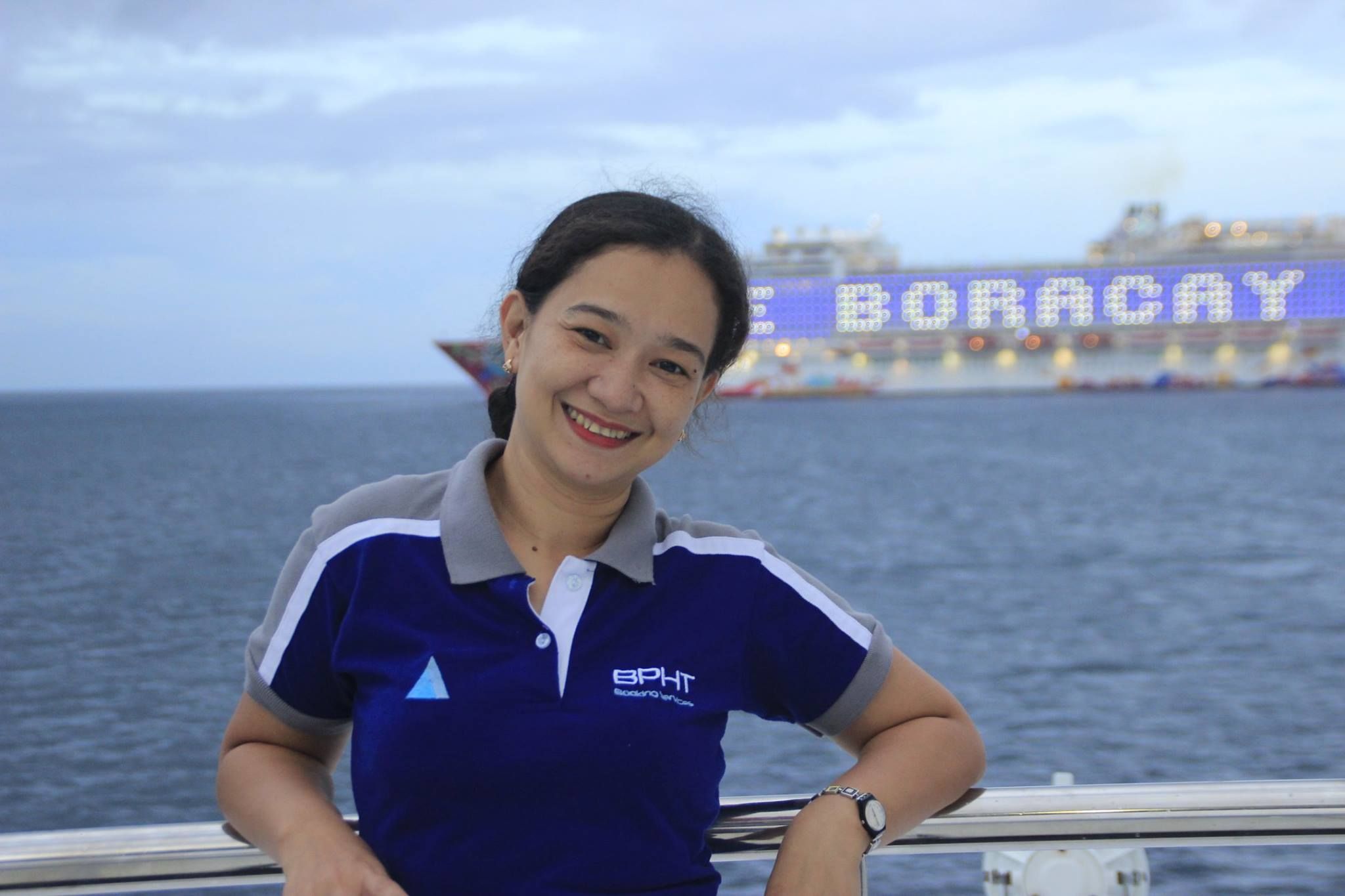 Mariel on a Yatch in Boracay and a cruise ship passing by.