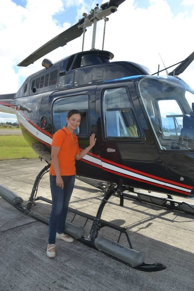 Mariel taking a photo in a helicopter tour