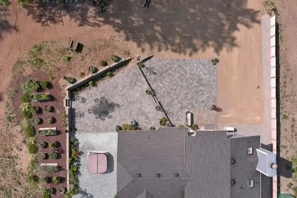 A sloped yard with fresh paving stones from a birds eye view above the home