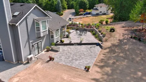 A view looking down on a new cobblestone patio installed in Bonney Lake, WA by FTS Excavation.
