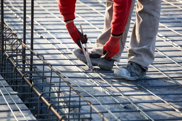 a worker reinforces a concrete foundation