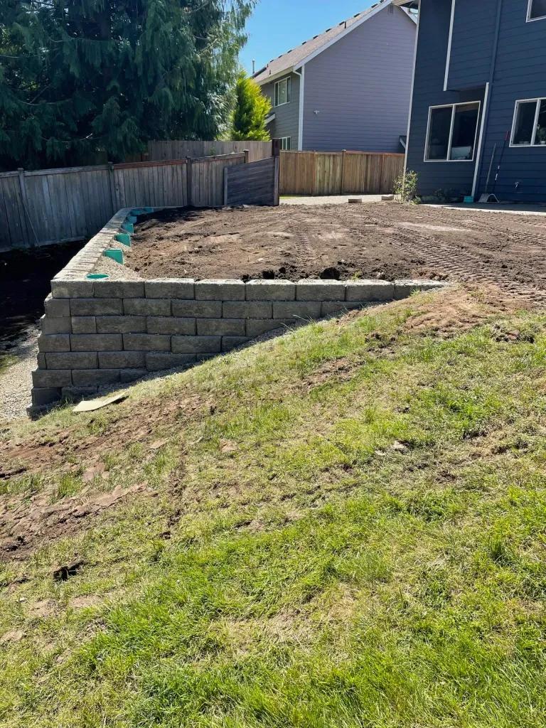 A new stack stone retaining wall installed by FTS Excavation