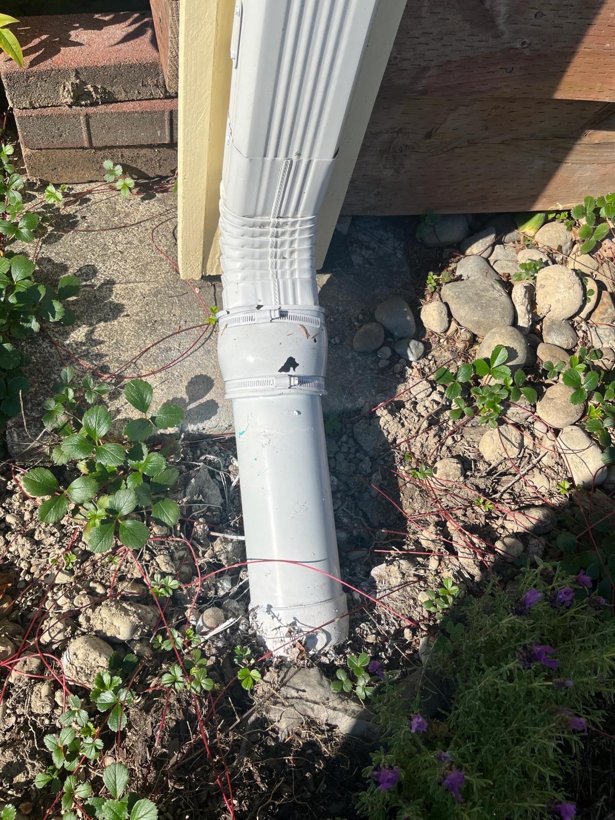 A gutter drain spout installed by FTS Excavation.