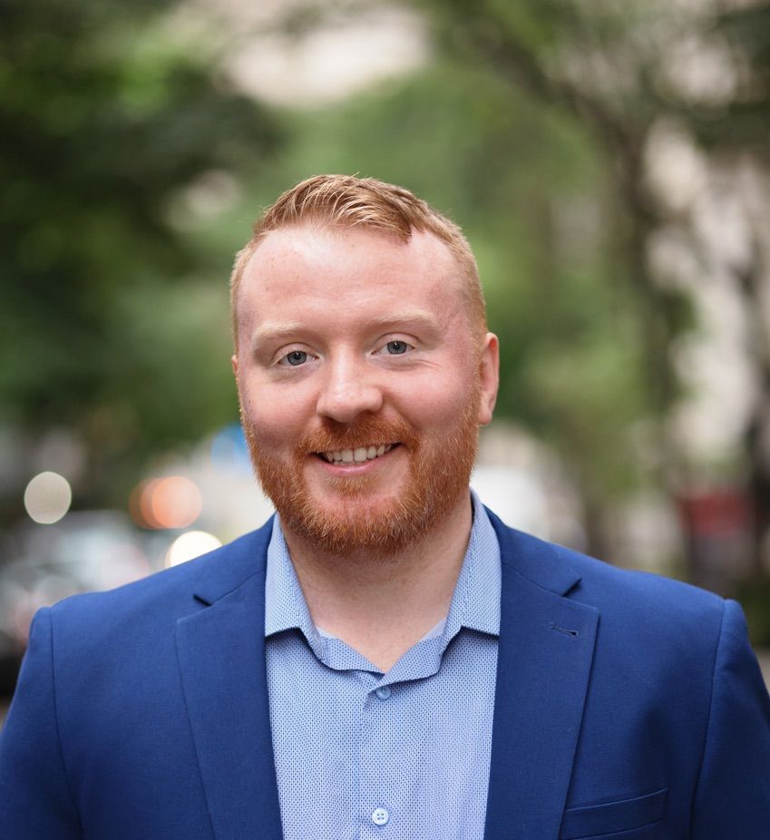 Dr. Daniel Lydon smiling outdoors in a blue jacket