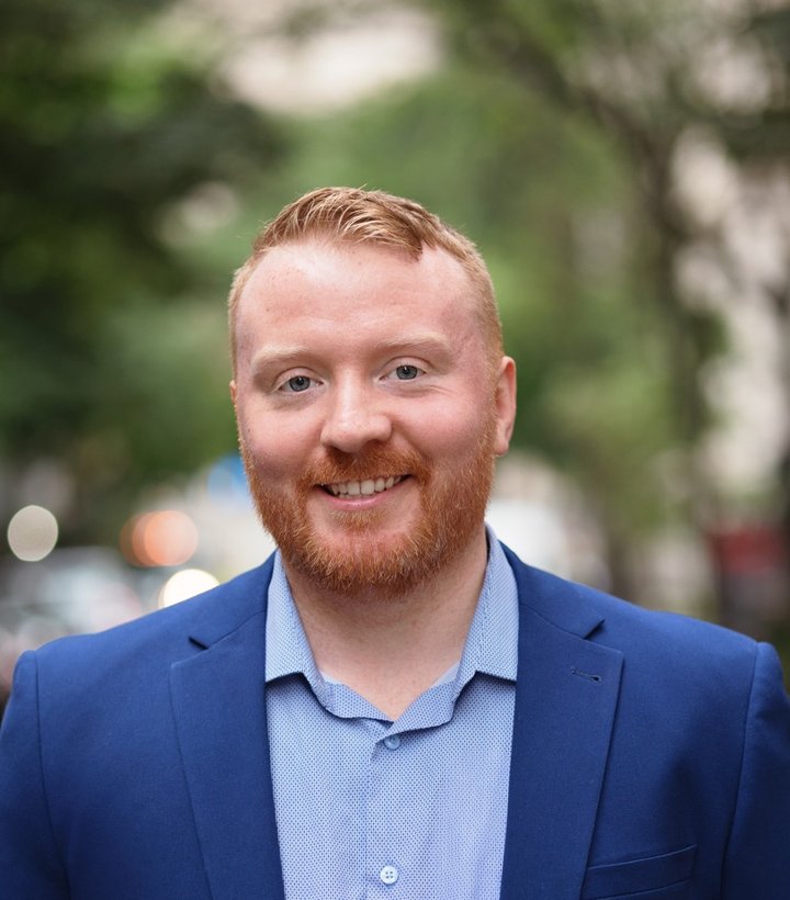 Dr. Daniel Lydon smiling outdoors in a blue jacket