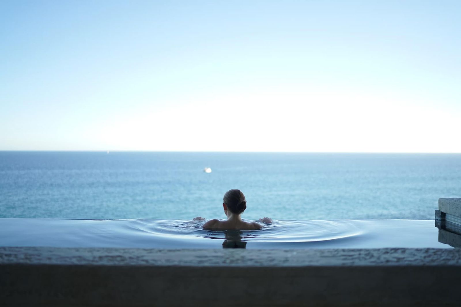 A swimmer at the edge of an infinity pool