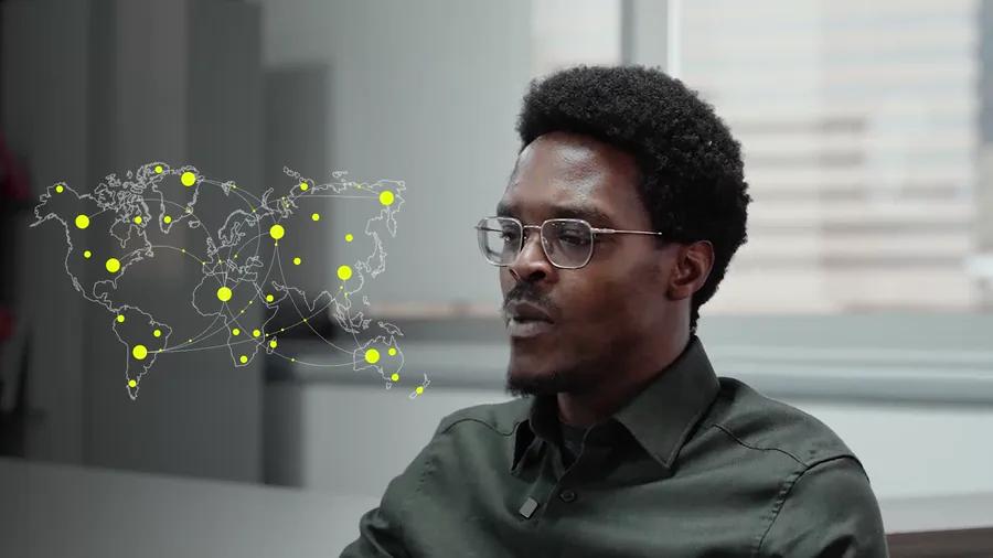 A world map rendered as a network of pale connecting lines with yellow nodes pulsing across it, overlaid beside a speaker in profile.