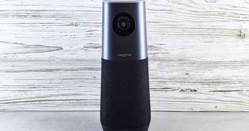 A sleek smart speaker with an integrated camera against a wooden backdrop, perfect for modern tech setups.