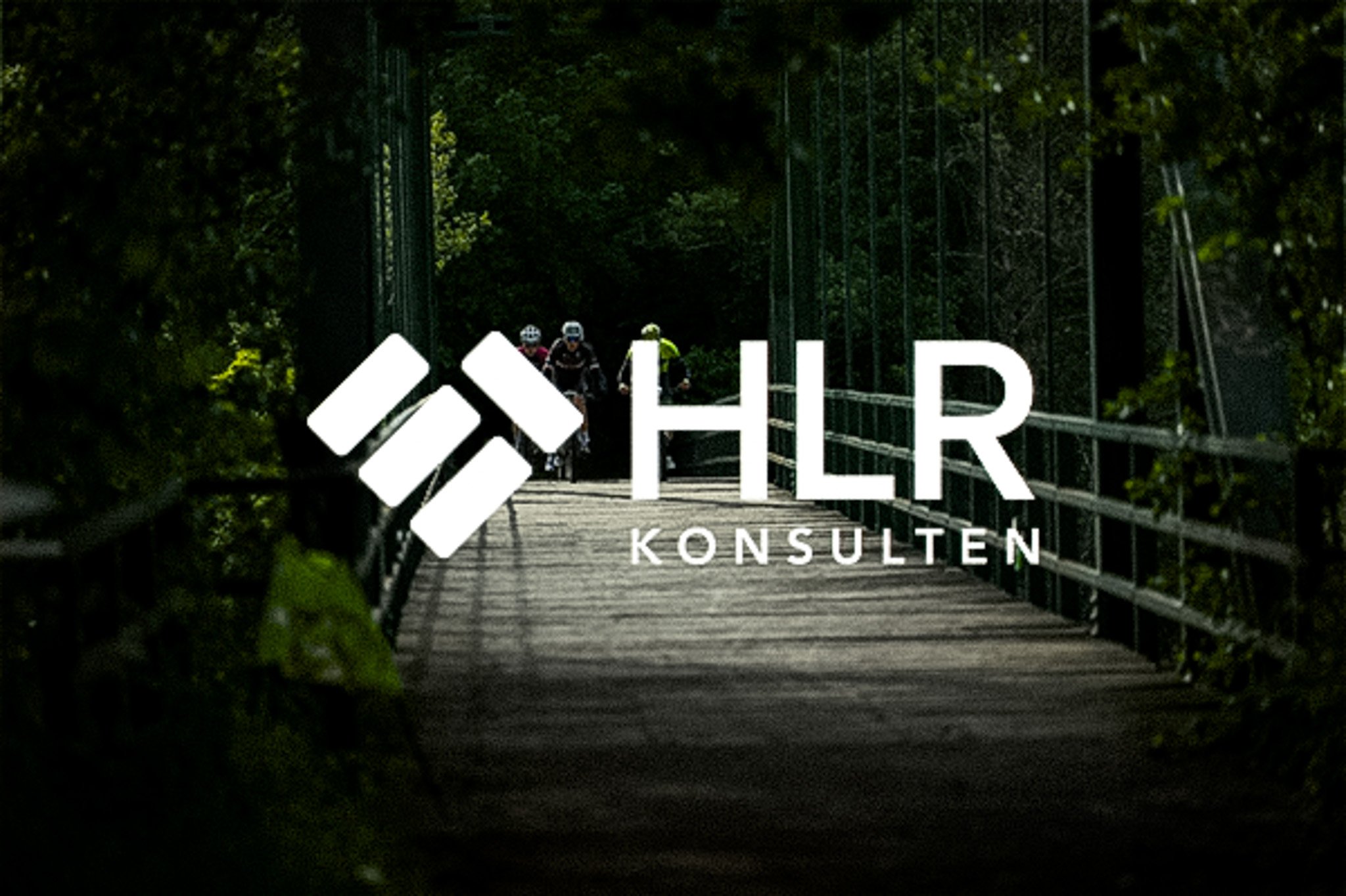 White HLR KONSULTEN logo over cyclists on a wooden bridge through green trees.