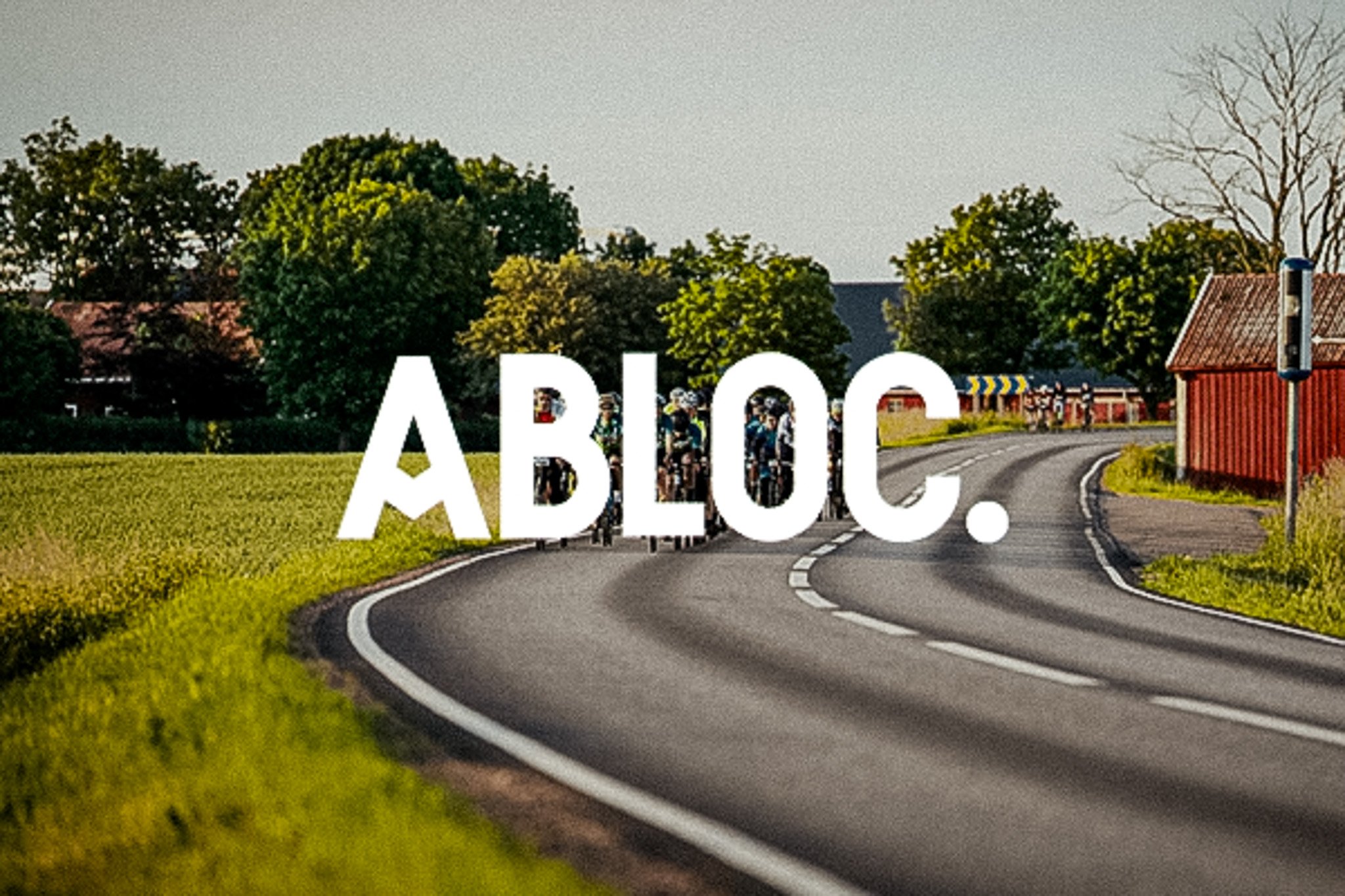 "ABLOC." text over an image of cyclists on a winding country road, with green fields, trees, and a red barn.