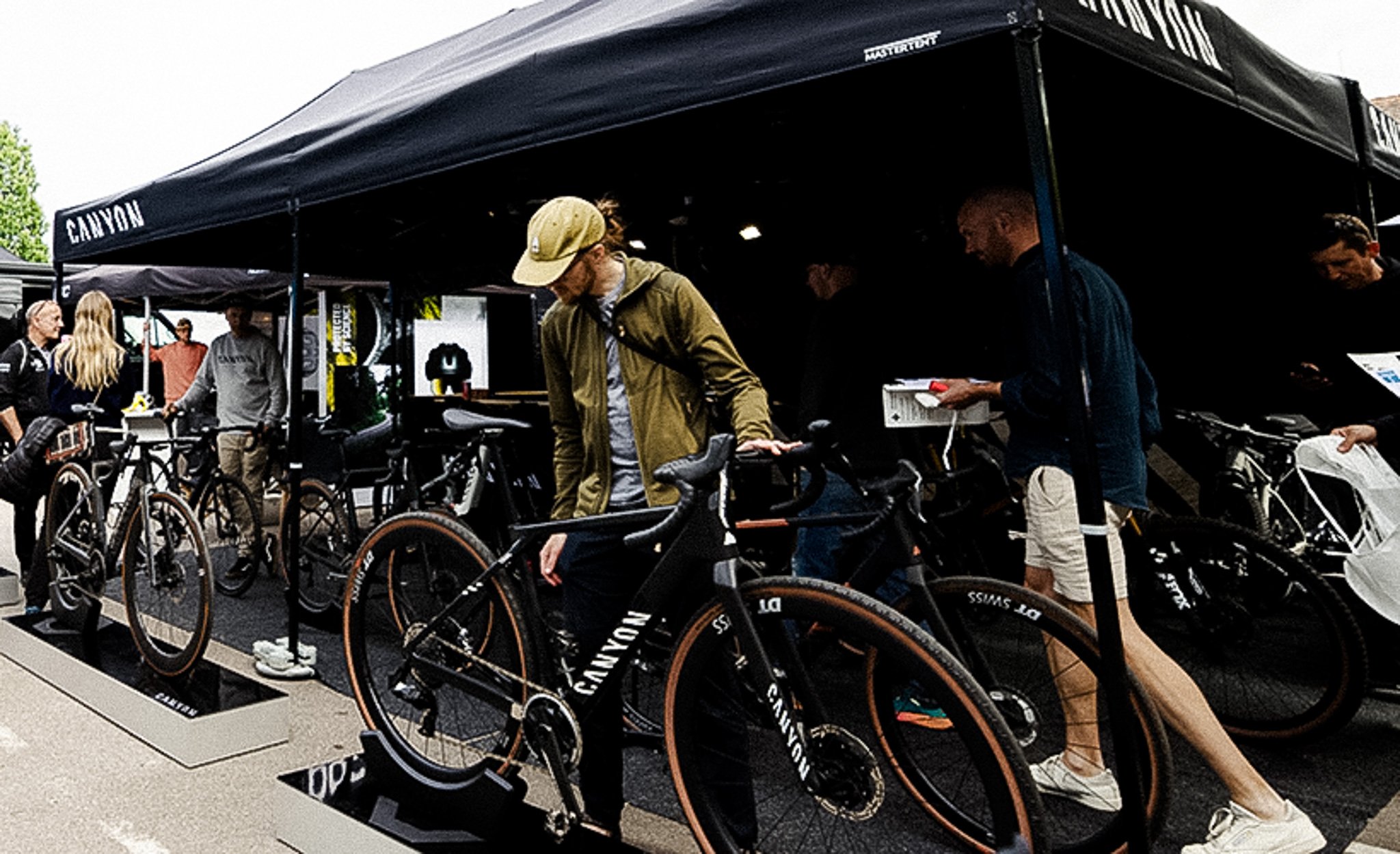 People browse Canyon bicycles at an outdoor event.