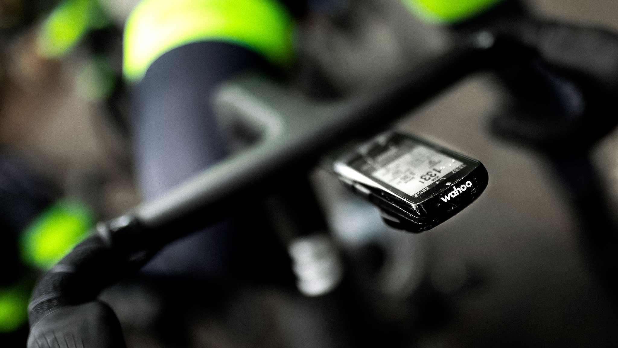 Close-up of a Wahoo bike computer mounted on bicycle handlebars, displaying data.