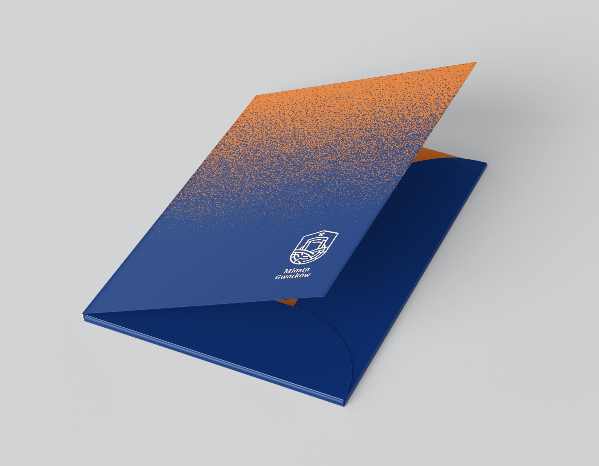 A company folder covered in an orange-to-navy gradient with a reversed emblem
