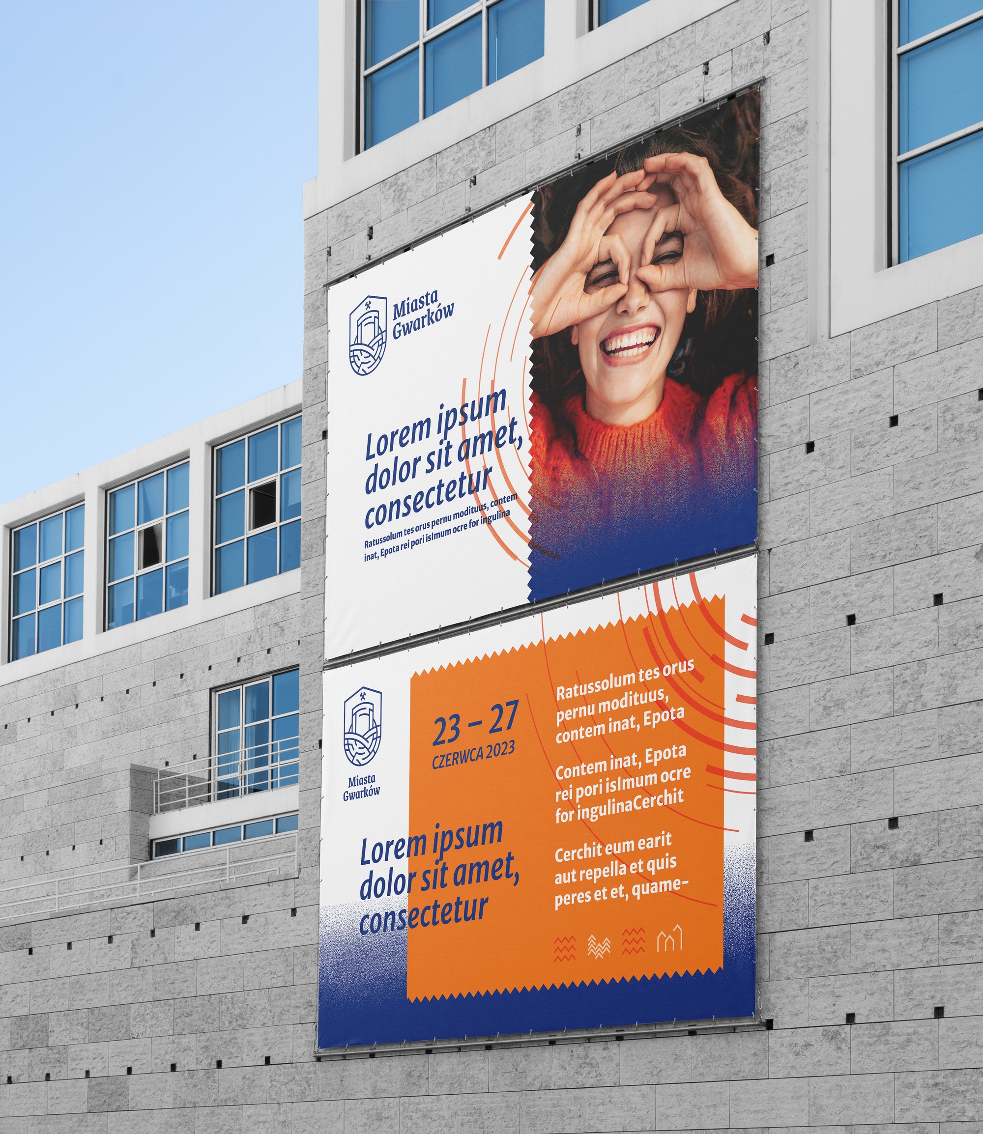 Two large-format Miasta Gwarków banners on a concrete façade