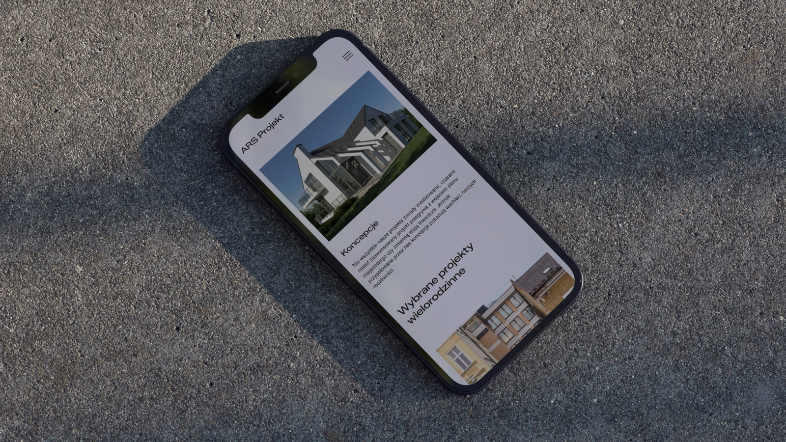 An iPhone with the Ars Projekt website, lying on concrete