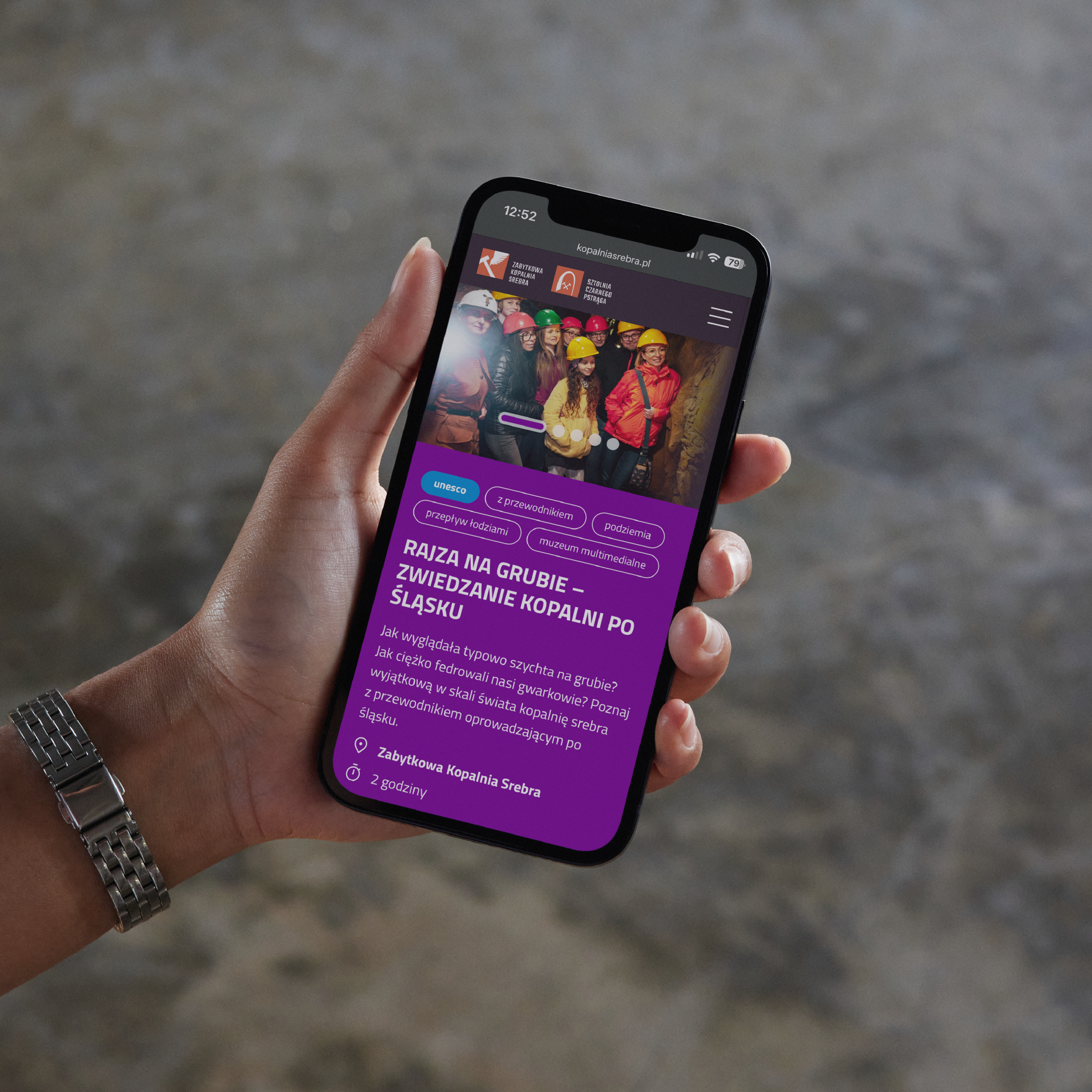 A woman's hand holding a phone with an event page of the Historic Silver Mine