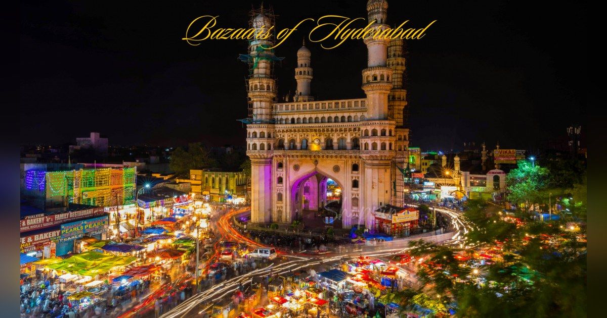Charminar lit up at night above busy Hyderabad streets