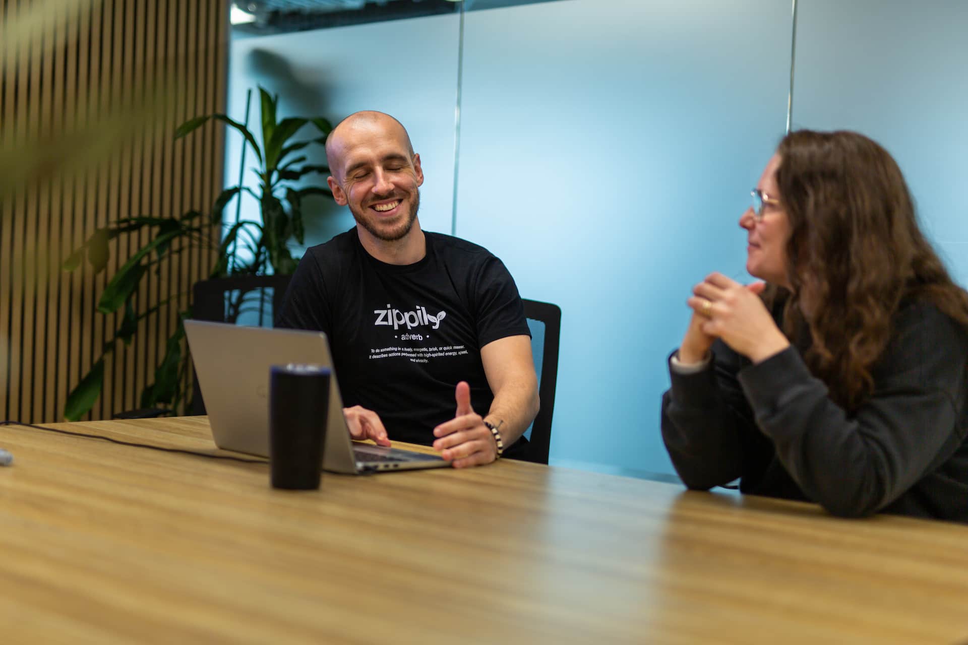 Zippily team members discussing work at a laptop