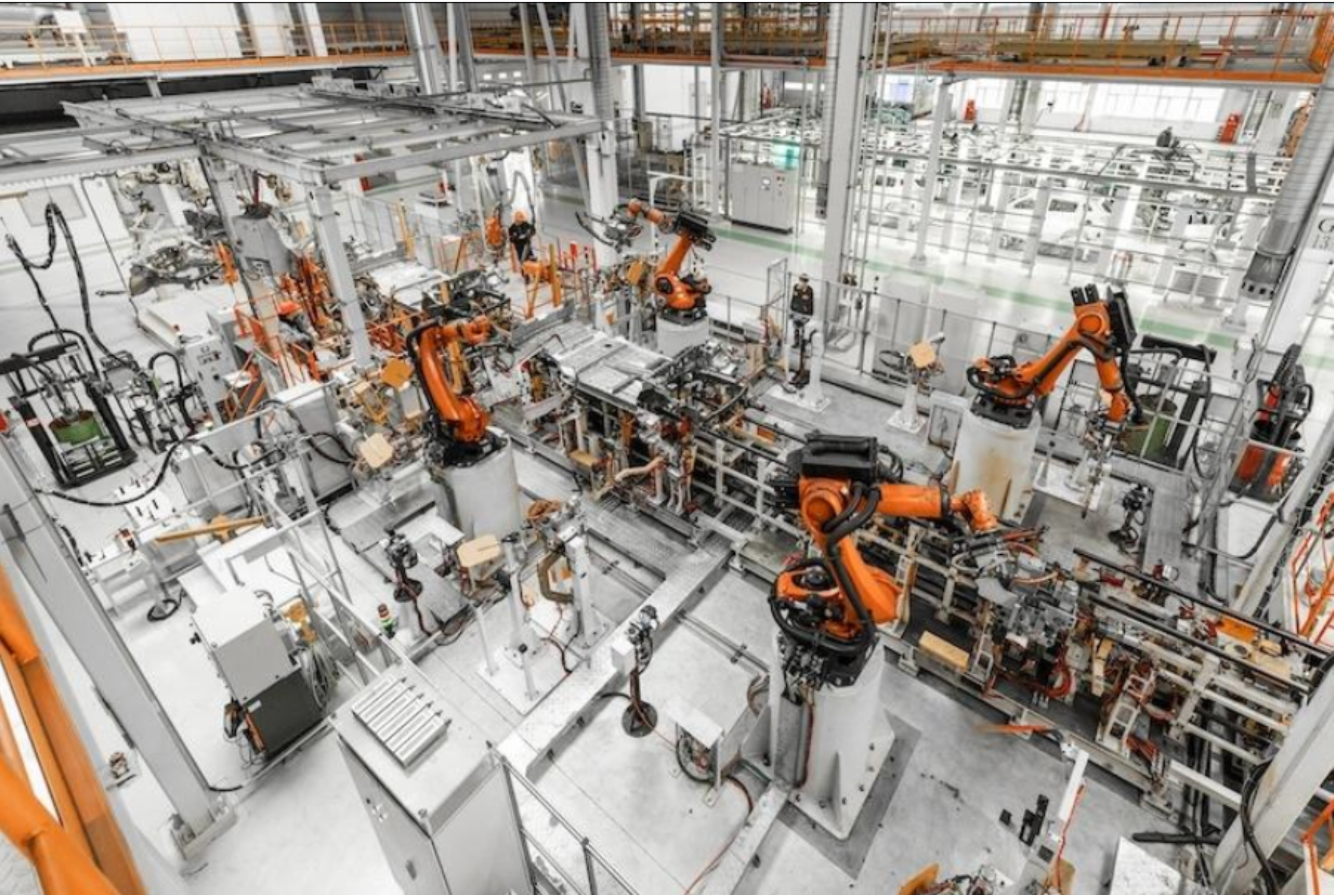 Automated factory floor with robotic arms, symbolizing advanced manufacturing and industrial competitiveness.