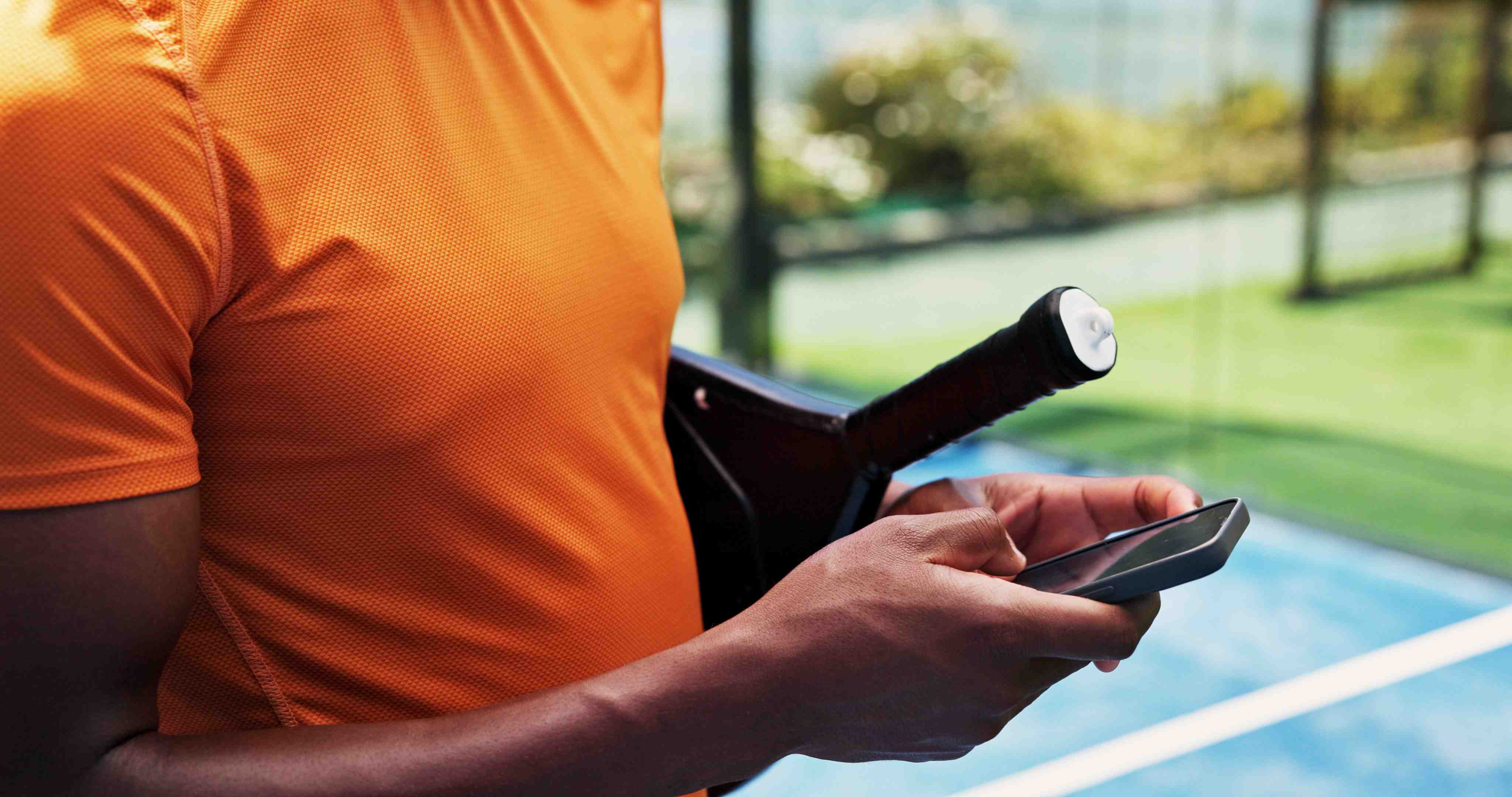 Padel player scrolling with phone Padel player scrolling with phone