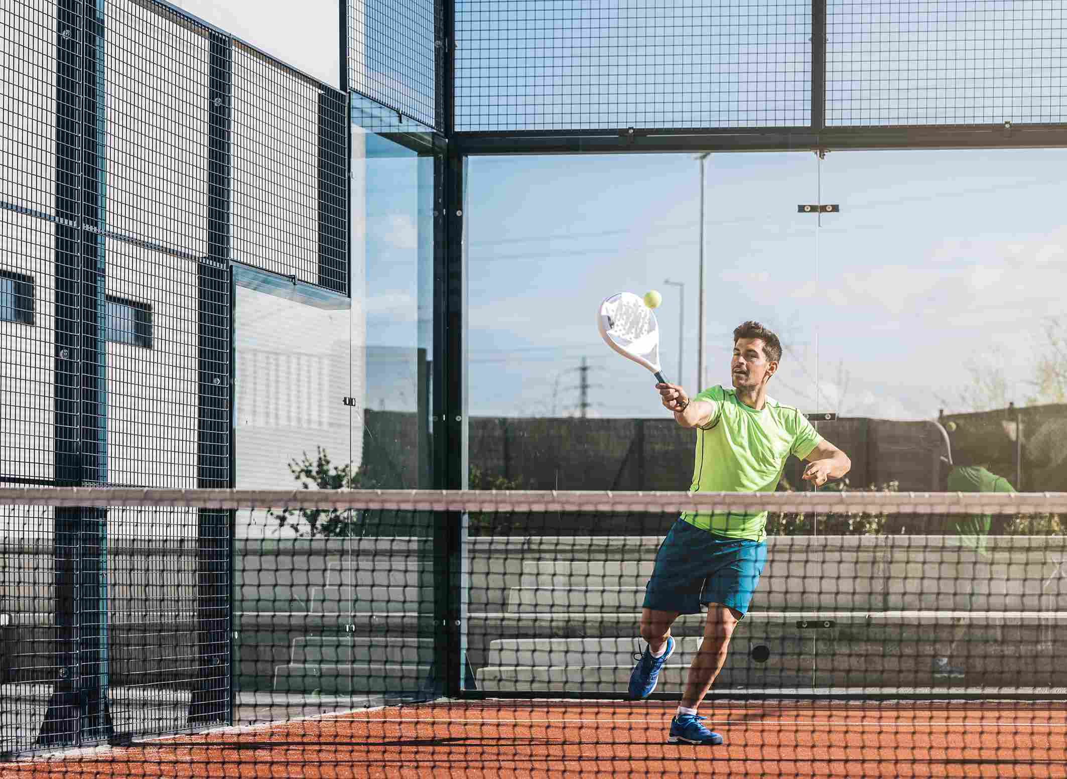 Man Playing Padel Tennis Outdoors 