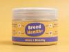 A jar of "Breed Health+" Joints & Mobility supplement for pets against a solid yellow background.