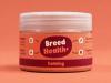 A jar of "Breed Health+" Calming supplement for pets against a solid peach background.