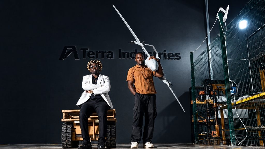 Nathan Nwachuku and Maxwell Maduka at Terra Industries' Abuja drone factory with the Archer UAV and autonomous ground chassis