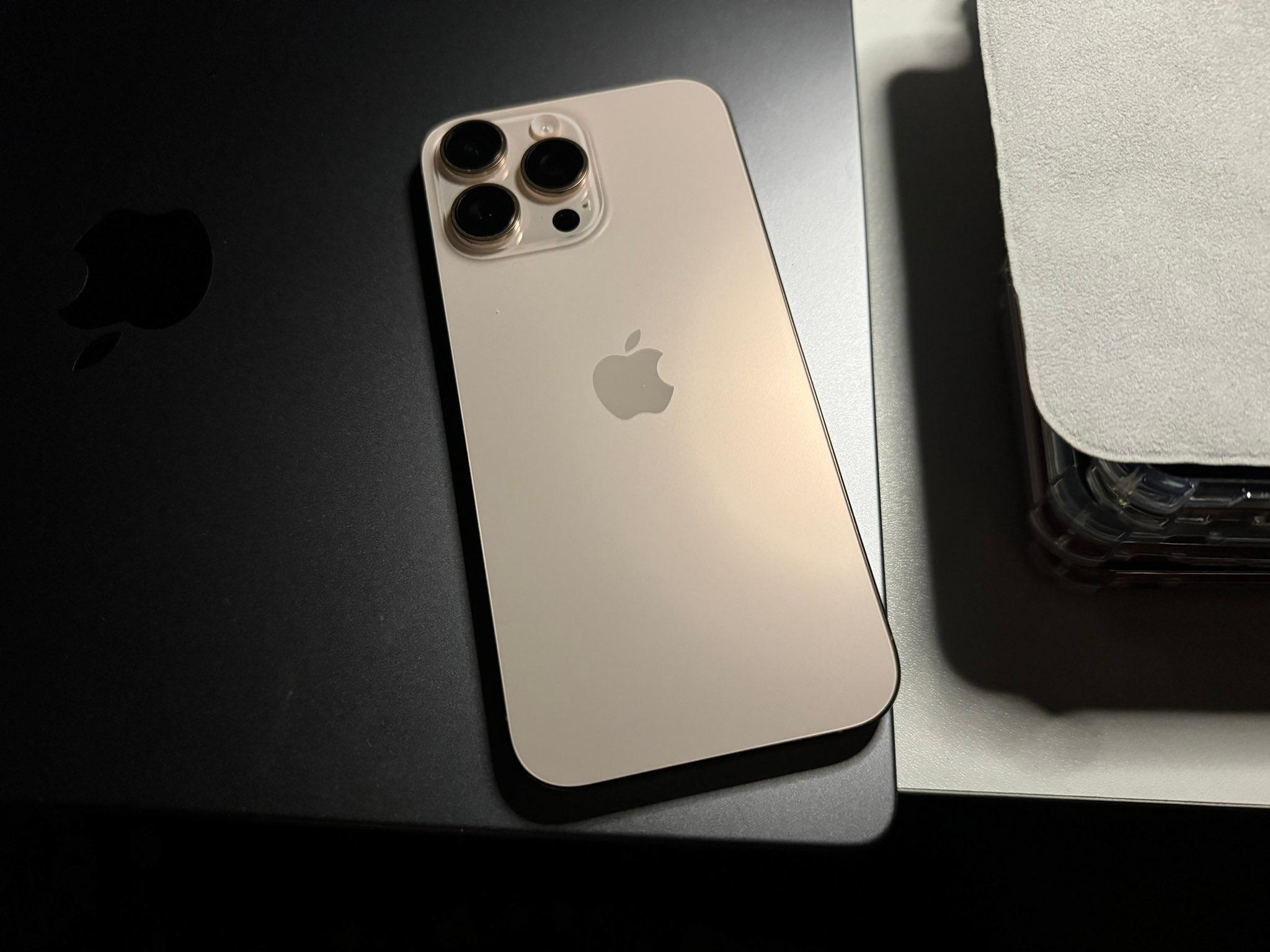 Apple iPhone 18 Pro Max in natural desert titanium showcasing the rear triple-lens camera module. Photo: Padgriffin (CC BY 4.0).