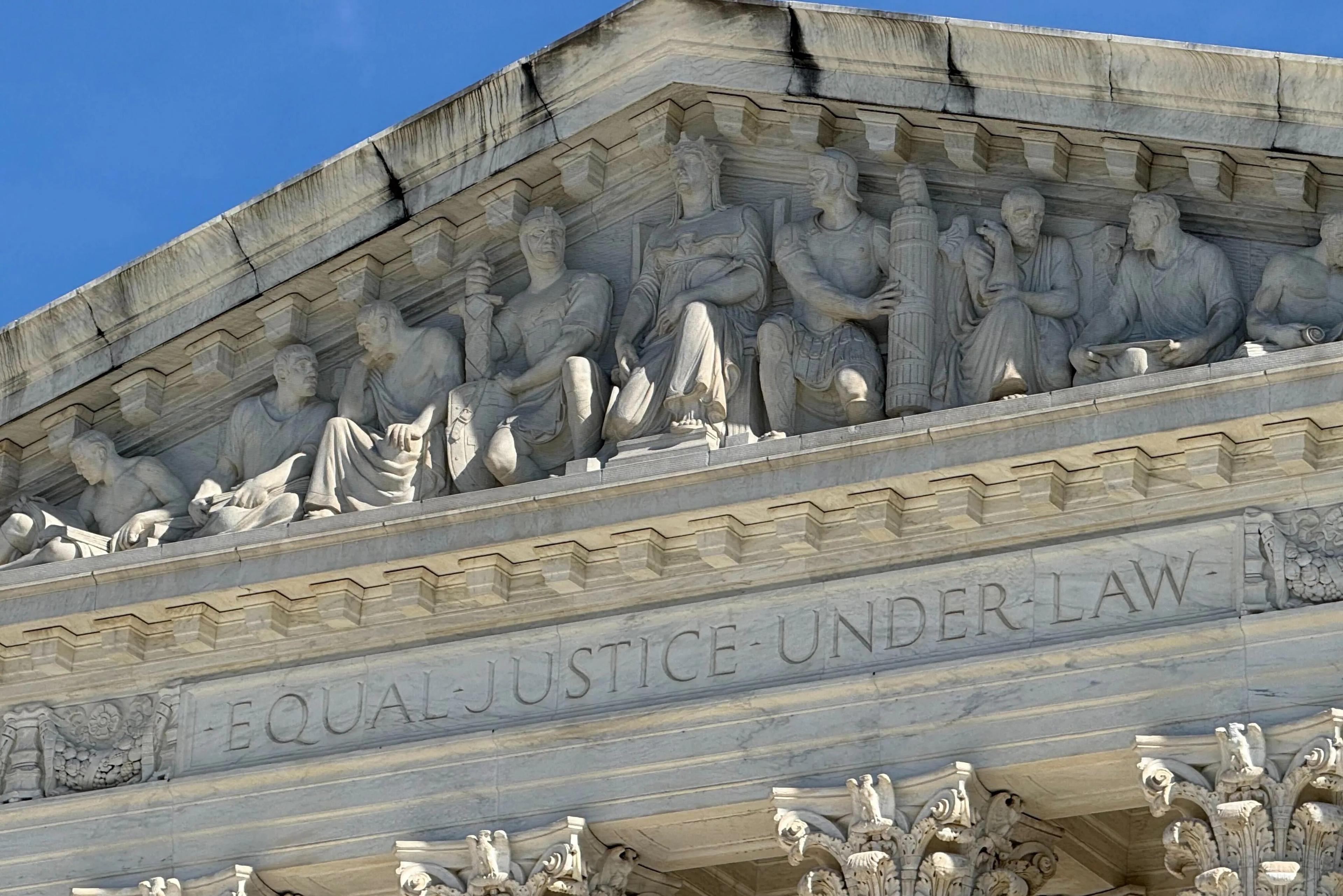 Carvings are shown at the top of the Supreme Court building