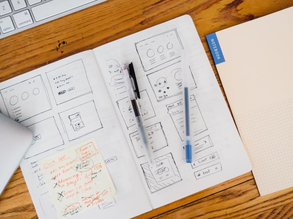 Application sketches and a pen on a desk