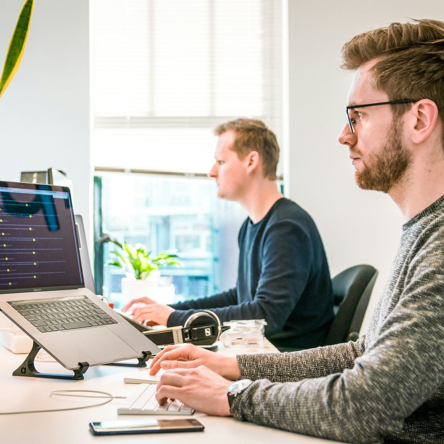 Two developers discussing work at a computer