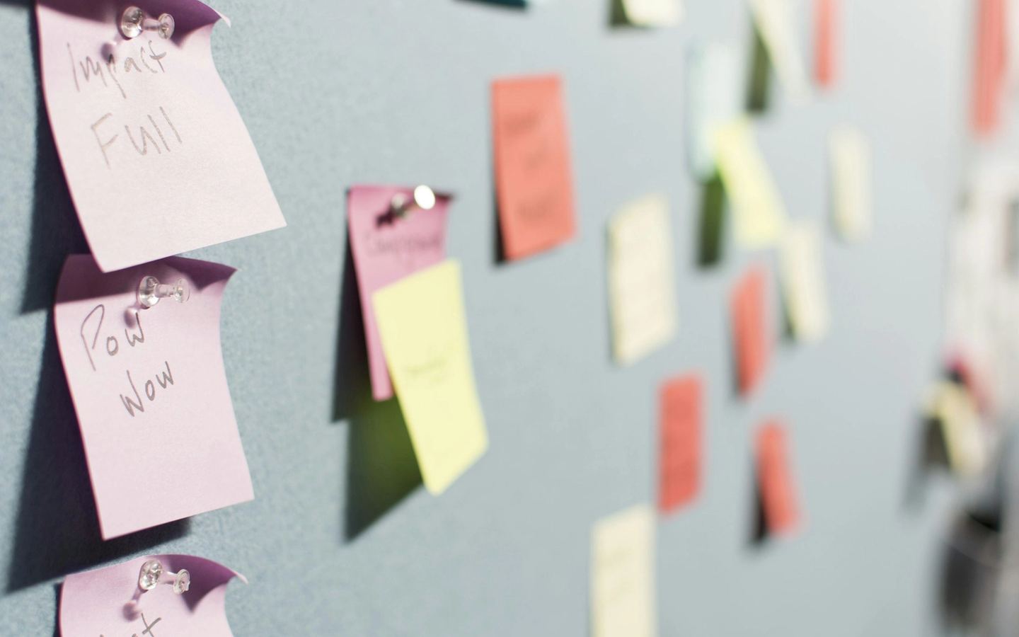 Colourful sticky notes on a board