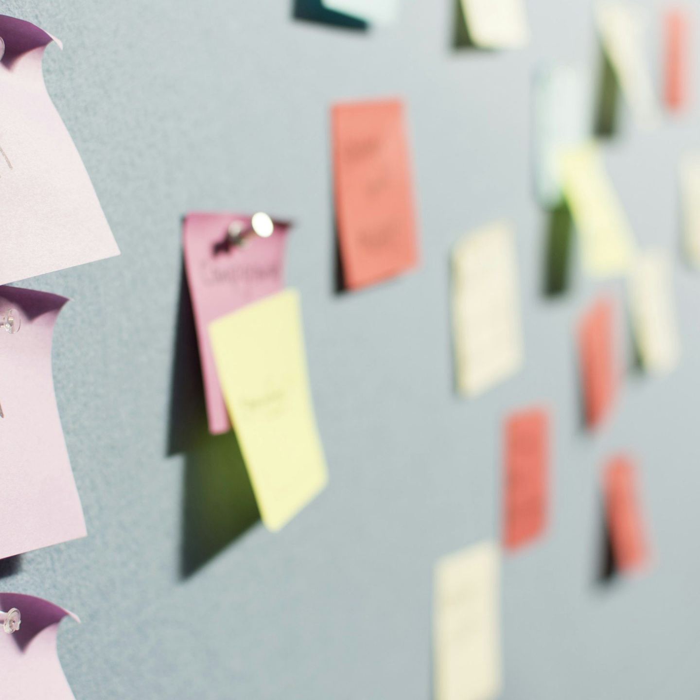 Colourful sticky notes on a board
