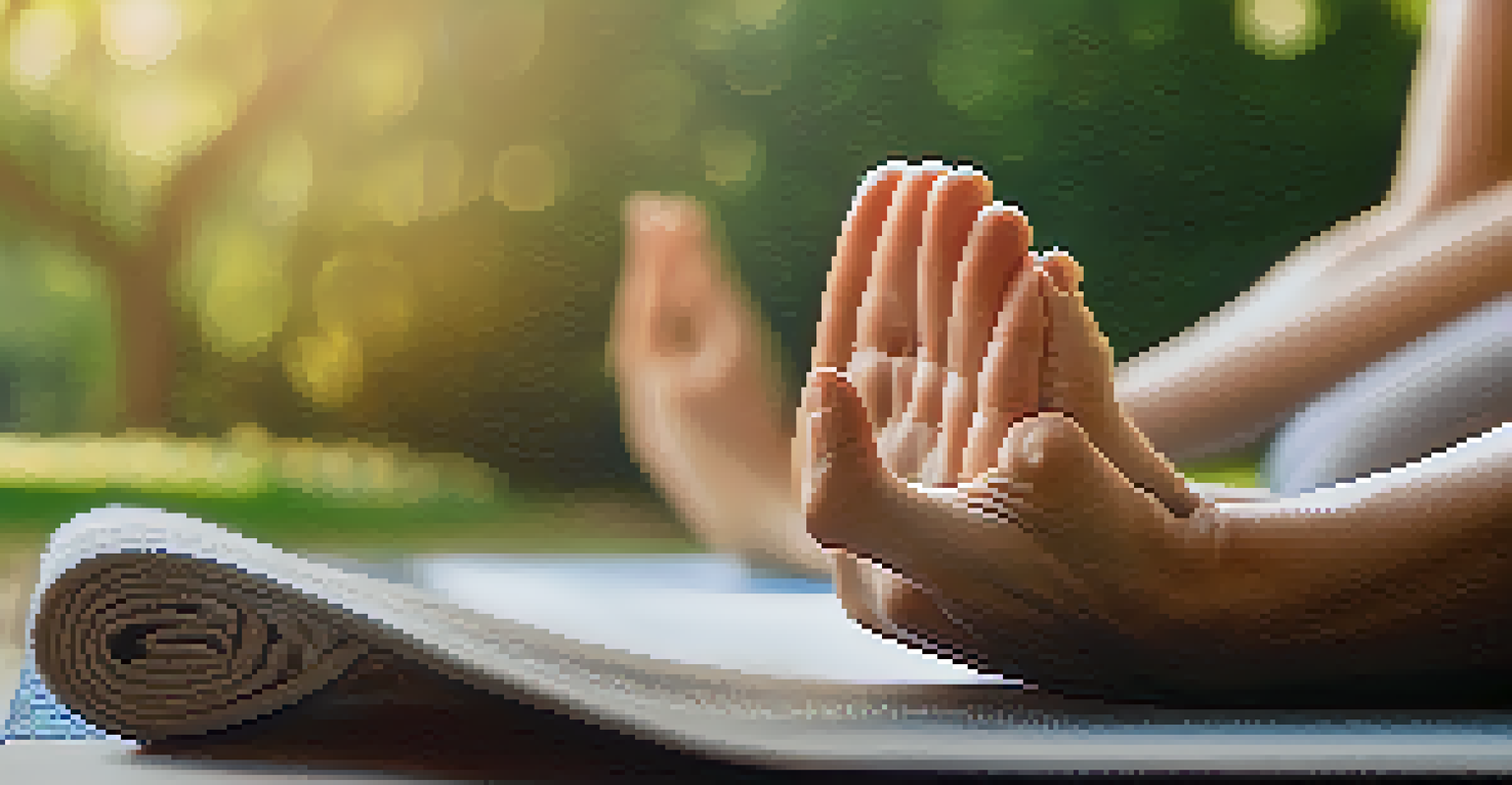 Close-up of hands performing a yoga mudra on a mat, with a blurred outdoor background filled with greenery and sunlight.